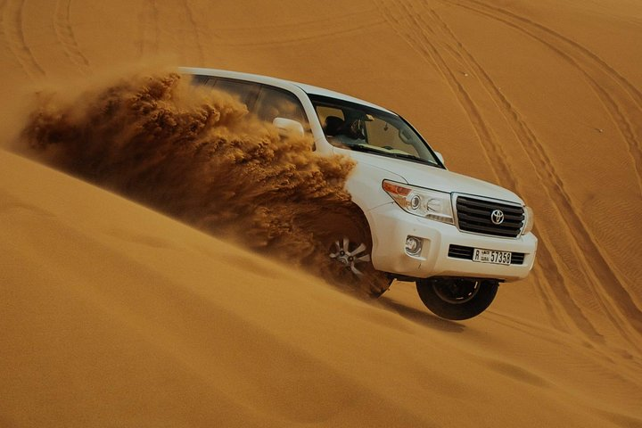 Experience the excitement of dune bashing in the stunning Dubai desert where endless golden sands create the perfect backdrop for an unforgettable adventure under the Arabian sky.